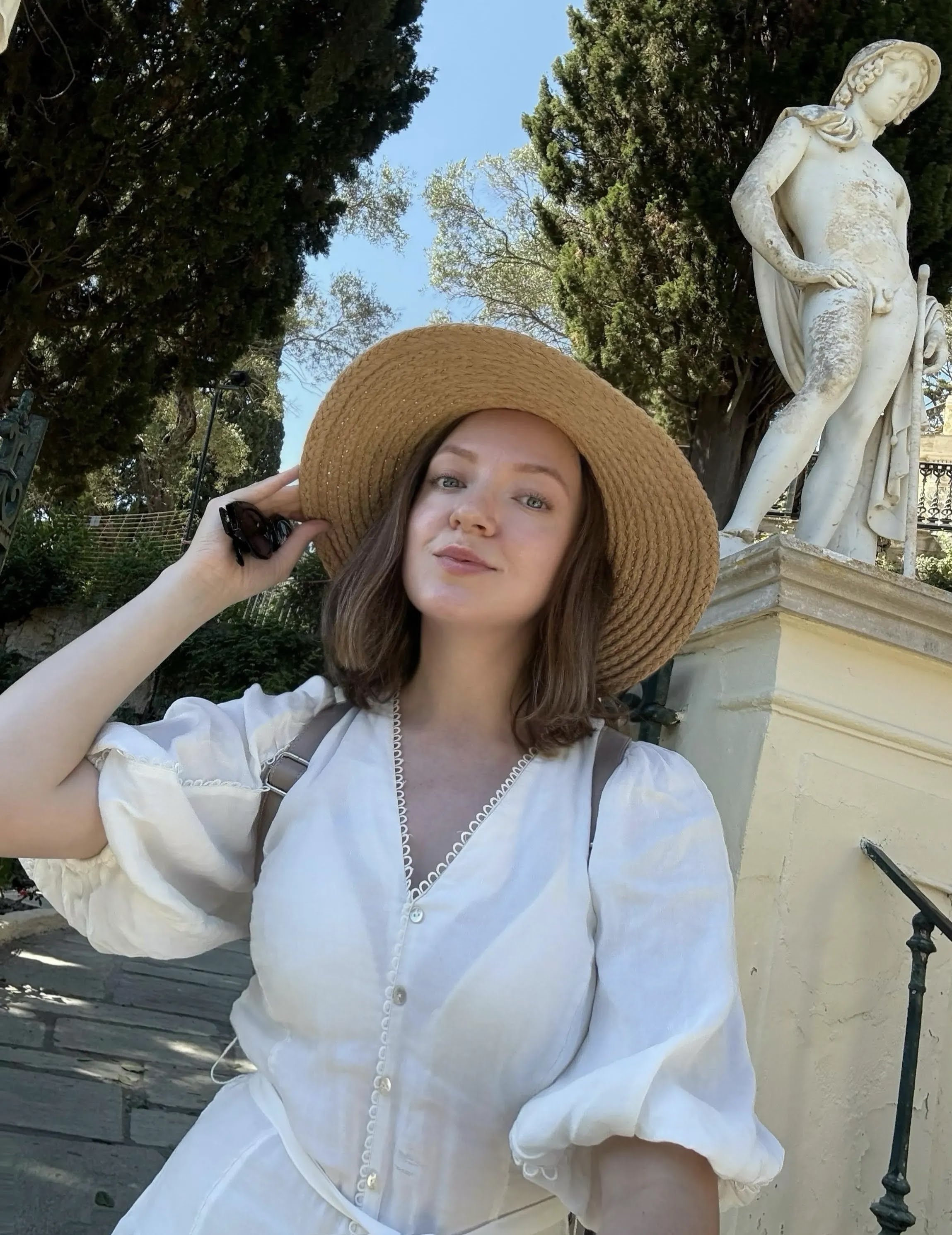 Anastasia wearing a sun hat while traveling